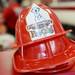 Red Firehouse Subs fire hats rest on the counter. Melanie Maxwell I AnnArbor.com